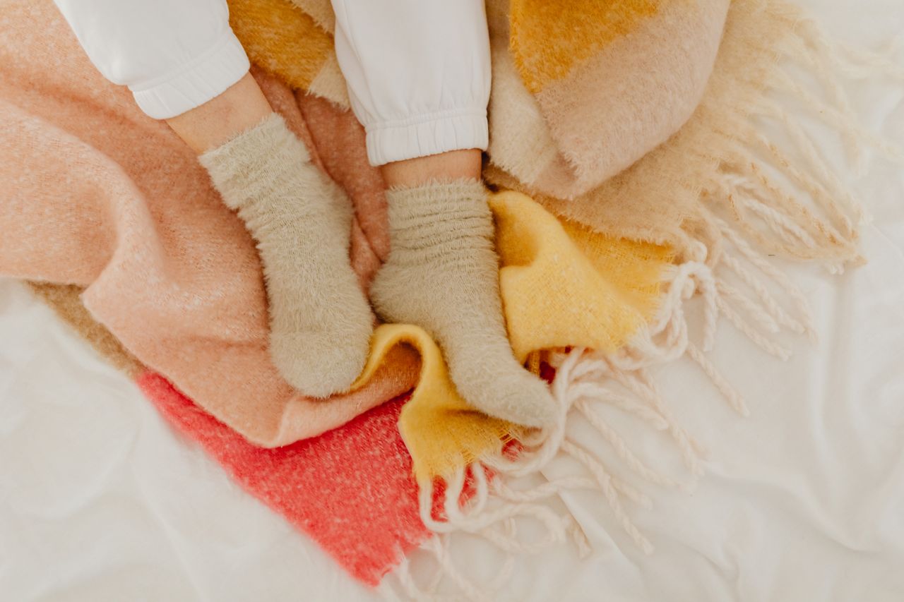 Comforting scene of socks and blankets conveying warmth and relaxation.
